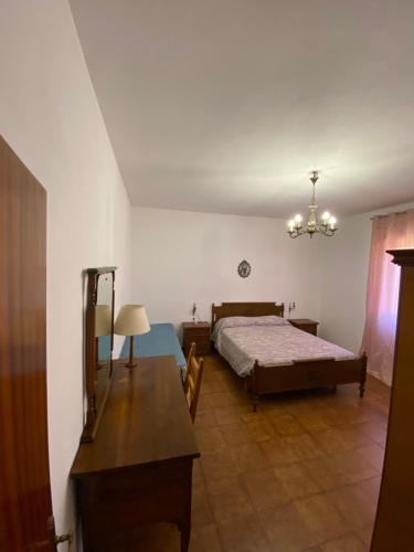 a bedroom with a bed and a table in a room at Pasquina and the Val d'Orcia in Vivo dʼOrcia