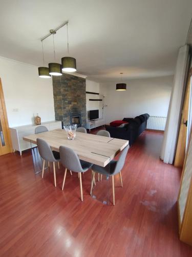 a dining room and living room with a table and chairs at Douro & Sabor Escape in Torre de Moncorvo