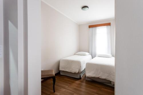 Ein Bett oder Betten in einem Zimmer der Unterkunft Hotel Carlton Plaza