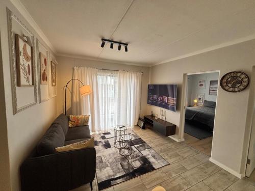 a living room with a couch and a bed at Seabreeze Summit Retreat Your Perfect Escape in Cape Town