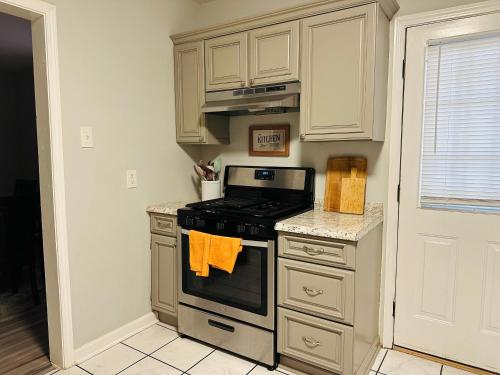 a kitchen with a stove top oven next to a door at Berclair Place in Memphis
