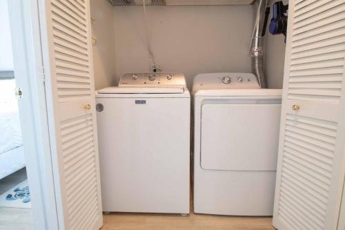 a laundry room with two washer and dryer at Pier Pleasure in Folly Beach
