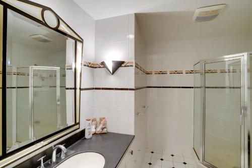 a bathroom with a sink and a shower at Pool Table and Deck Luxury Mansion in Niskayuna! in Niskayuna