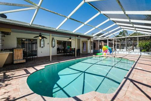 an indoor swimming pool with a glass roof at 3 Mi to Weeki Wachee Springs SP Poolside Oasis! in Spring Hill