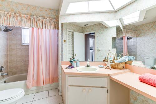 a bathroom with a sink and a tub and a toilet at 3 Mi to Weeki Wachee Springs SP Poolside Oasis! in Spring Hill