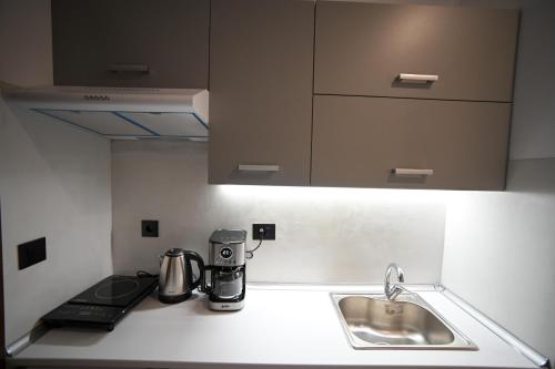 a kitchen with a sink and a coffee maker on the counter at Hera Elegant Suite by Zeus Suites in Athens