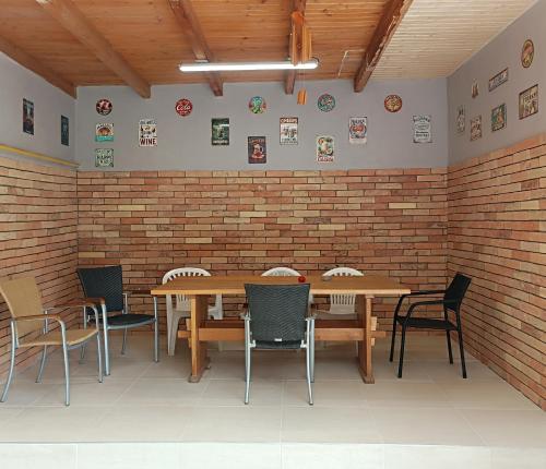 a dining room with tables and chairs and a brick wall at Mendi in Štúrovo