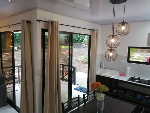 a kitchen with sliding glass doors to a patio at Cabañas Mantas in Tarcoles