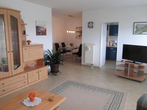 a large living room with a television and a table at Ferienwohnungen an der Therme in Bad Rodach