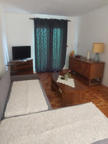 a living room with a couch and a table at Dudino jezersko gnezdo in Bor