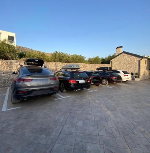 a row of parked cars in a parking lot at Villa Donatella in Podstrana