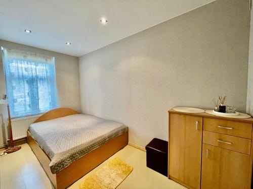 a small bedroom with a bed and a window at ''Rozā namiņš'' in Ventspils