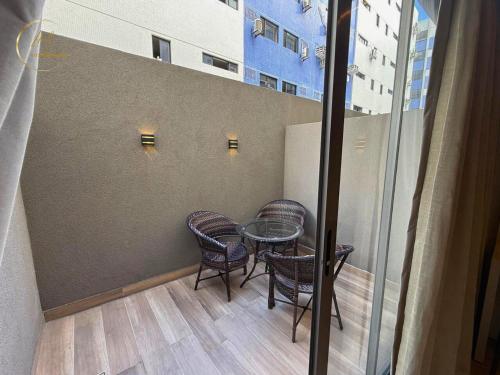 a table and chairs in a room with a window at LM Setai Yacht Cabo Branco in Tambaú