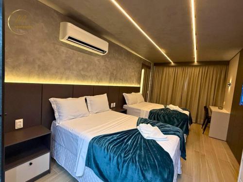 a hotel room with two beds and a heater at LM Setai Yacht Cabo Branco in Tambaú
