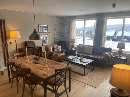 a living room with a table and a couch at Åre Sadeln Ski in ski out in Åre