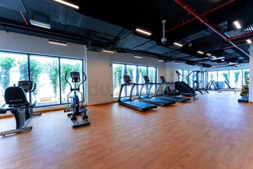 a gym with treadmills and elliptical machines at Affordable Luxury Capsule Bed in Downtown Dubai Near Metro in Dubai
