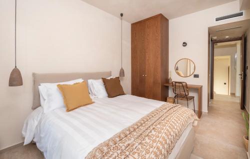 a bedroom with a large white bed and a desk at Forest View Villas in Lagoúdi Zía