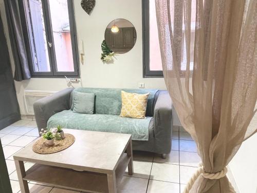 a living room with a couch and a table at Les Studios de la Bastide in Carcassonne