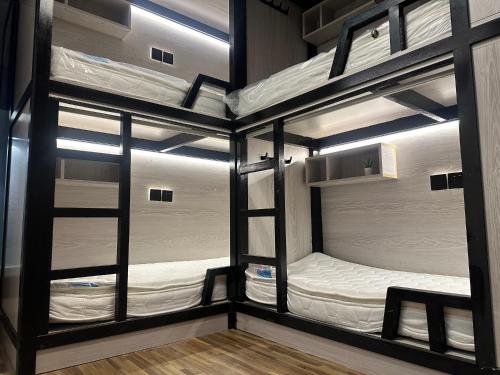 two bunk beds in a room with windows at Affordable Luxury Capsule Bed in Downtown Dubai Near Metro in Dubai