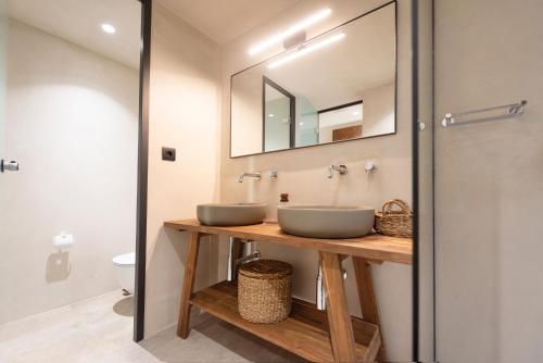 a bathroom with two sinks and a mirror at Forest View Villas in Lagoúdi Zía