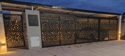 a fence with a bunch of wine bottles on it at Chacabuco Aparts in Chacabuco