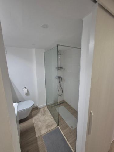 a bathroom with a toilet and a glass shower at Lux Studio Porto in Tivat