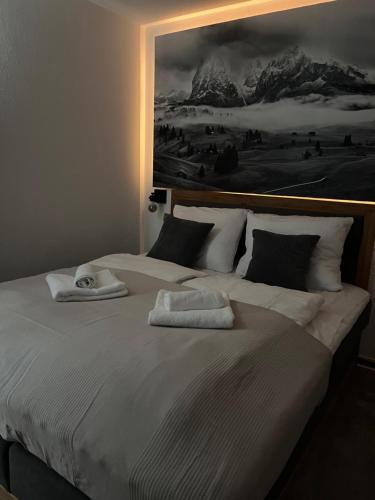 a bedroom with a bed with two towels on it at Alpenruhe Kranzegg in Rettenberg