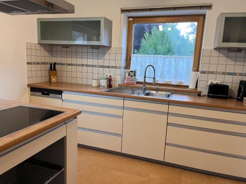 a kitchen with a sink and a window at Alpenruhe Kranzegg in Rettenberg
