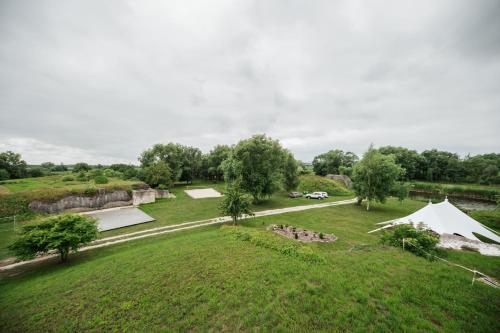 an overhead view of a field with a tent at Archers island apartment with HOT TUB in Liepāja