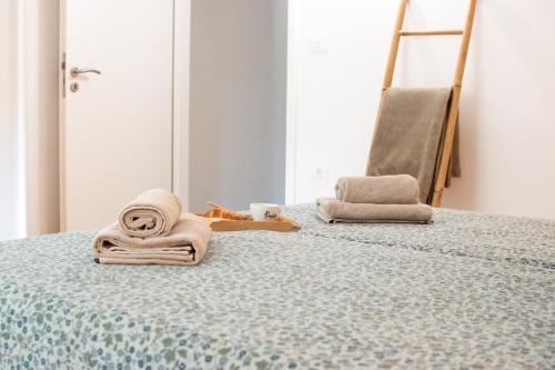 a bedroom with a bed with a towel on it at Heart of Istria in Stari Pazin