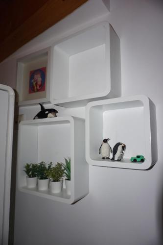 a white refrigerator with two shelves with potted plants at Casa de Gondramaz - Galeria com Vista Serra in Miranda do Corvo