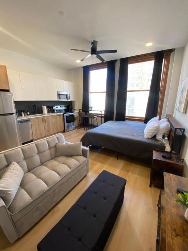 a living room with a couch and a bed at Optimum - Downtown Oasis in Birmingham