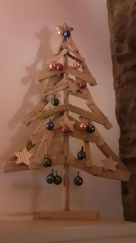 a wooden christmas tree hanging on a wall at Casa de Gondramaz - Galeria com Vista Serra in Miranda do Corvo