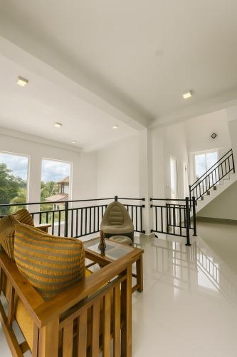 a living room with a couch and a table at Colombo Airport Villa by J-Villas in Ja-Ela