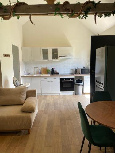 a living room with a couch and a table at La jungle in Saint-Nicolas-dʼAliermont