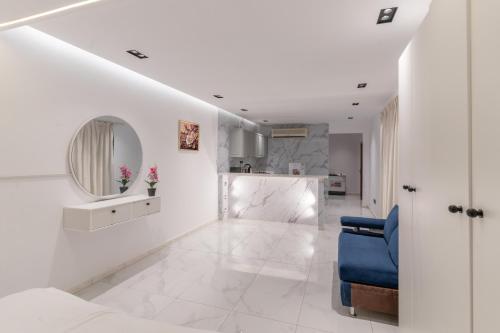 a white room with a blue couch and a mirror at شقق ابحر المفروشه in Jeddah