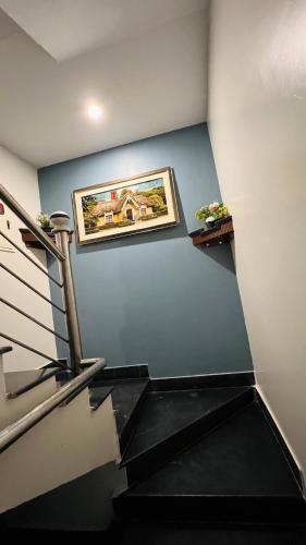 a stairway with a painting on the wall at Karachi Inn in Karachi