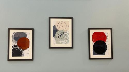 a group of four framed pictures on a wall at Karachi Inn in Karachi