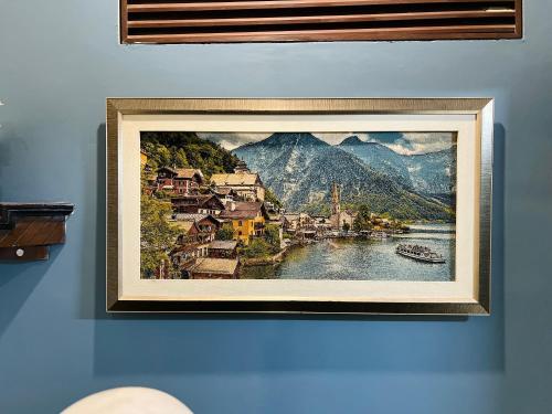a framed picture of a town on a wall at Karachi Inn in Karachi