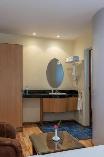 a room with a sink and a mirror on the wall at Best Western Nairobi Upper Hill in Nairobi