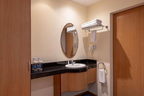 a bathroom with a sink and a mirror at Best Western Nairobi Upper Hill in Nairobi