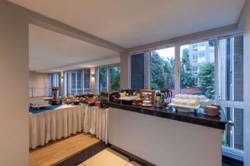 a breakfast buffet in a room with large windows at Best Western Nairobi Upper Hill in Nairobi