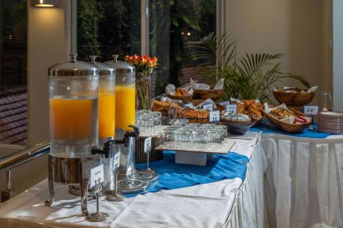 a table with bottles of orange juice and snacks at Best Western Nairobi Upper Hill in Nairobi
