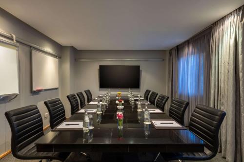 a conference room with a long table and chairs at Best Western Nairobi Upper Hill in Nairobi