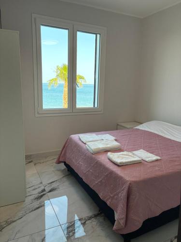 a bedroom with a bed with two towels on it at Miramare in Crotone