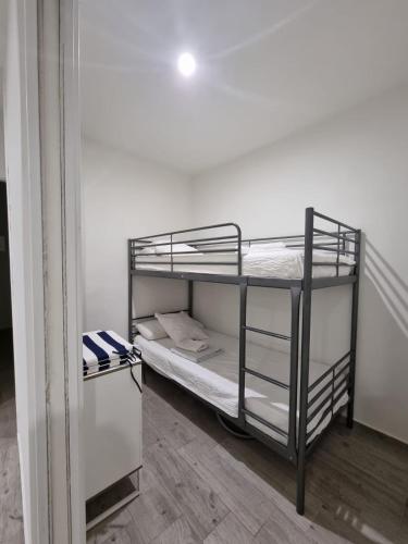 a bedroom with two bunk beds in a room at Apartamento Puerto Blanes in Blanes