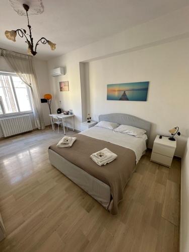 a large bedroom with a large bed and a table at La casa di Anna in Lamezia Terme