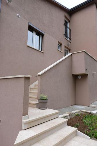 a building with stairs and a plant in a pot at Heart of Istria in Stari Pazin
