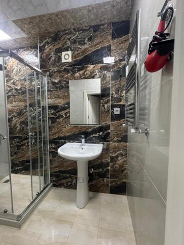 a bathroom with a sink and a glass shower at Boulevard Sumgait in Sumqayyt
