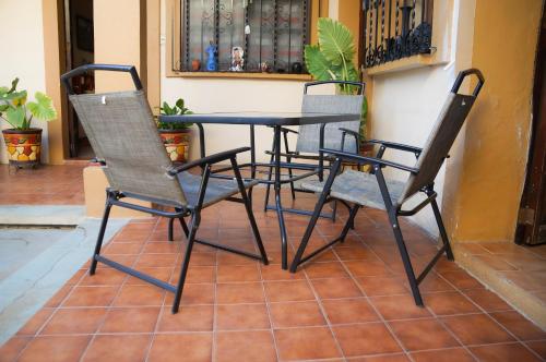 two chairs and a table on a patio at Casa de Alicia Habitación Mitla in Oaxaca City
